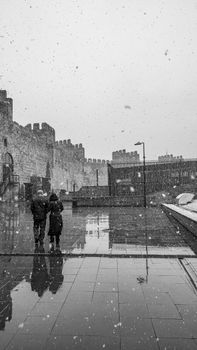 A couple walks in snowy Kayseri, Türkiye, in this monochrome winter scene.