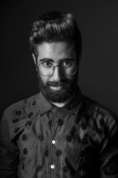 Grayscale Photography of Man Wearing Eyeglasses