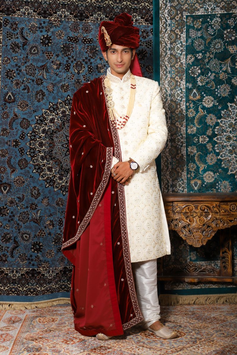 Groom in white sherwani with red dupatta