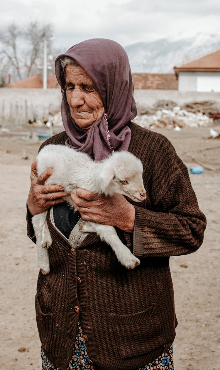 Elderly Woman Holding A Lamb