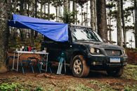 Off-Road Car Standing by Picnic Place in Forest