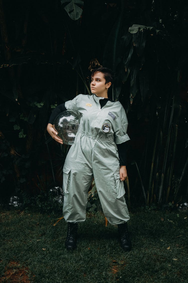 Girl In Odd Overalls Carrying Glass Ball Under Arm