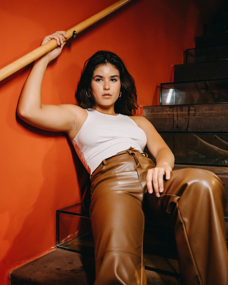 Brunette Teenage Girl Sitting On Stairs In Careless Pose