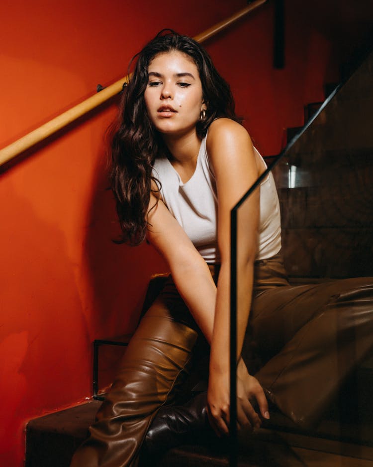 Young Brunette Woman Sitting And Posing On Stairs