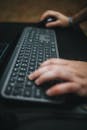 Mans Hands on Keyboard and Mouse