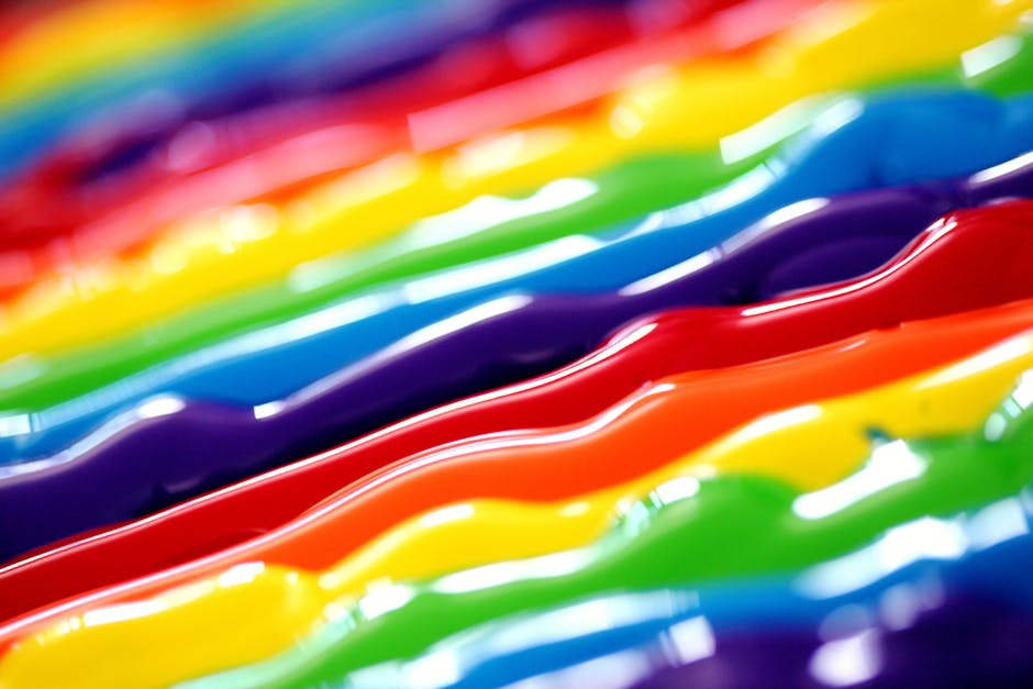 A vibrant abstract background featuring flowing rainbow colors in a creative artistic style.