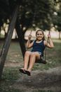 Smiling Girl on a Swing