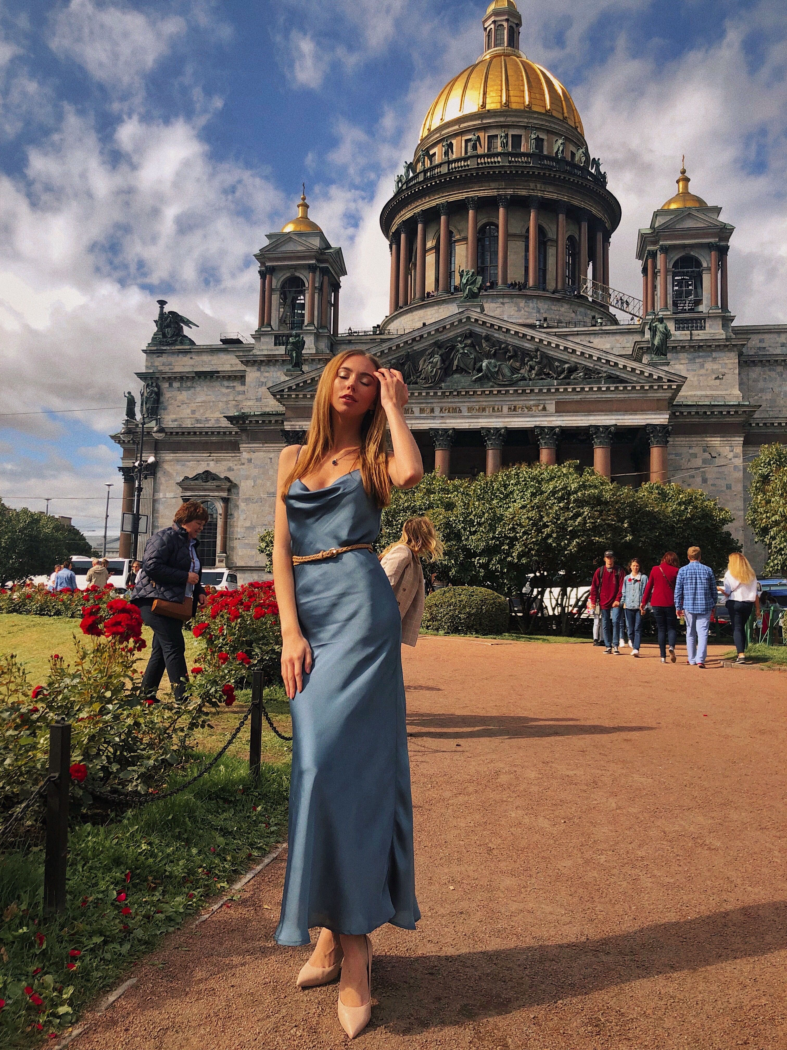 Woman in Blue Dress Standing near a Cathedral · Free Stock Photo