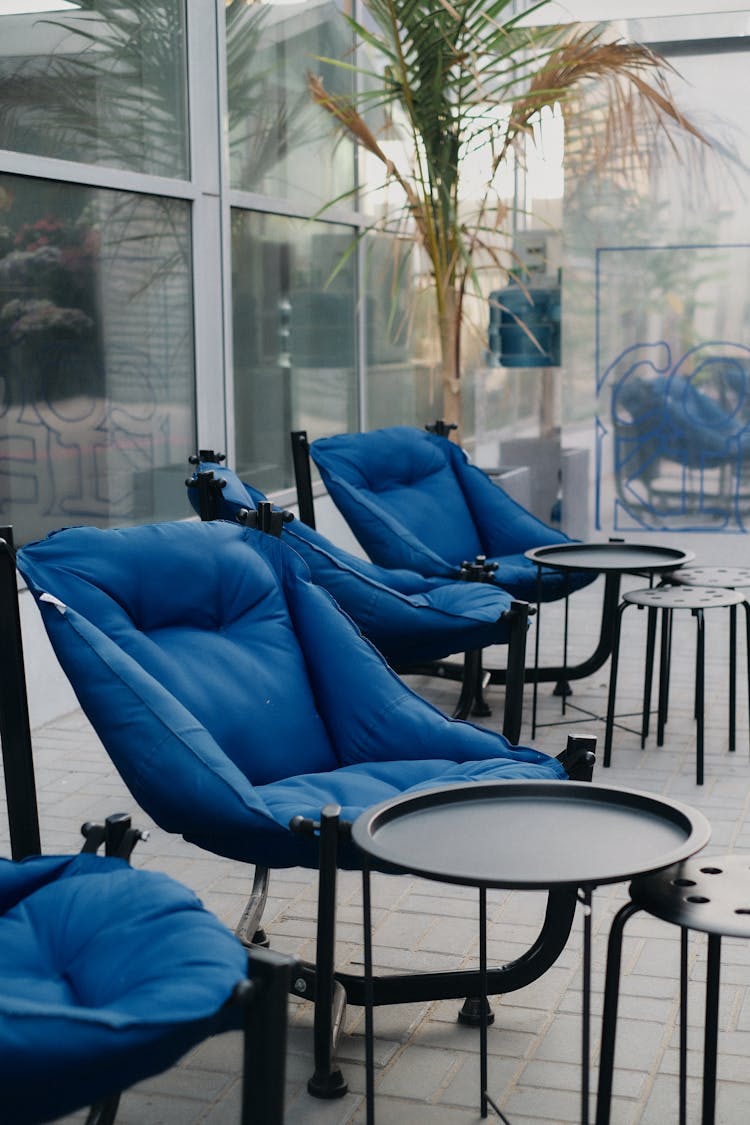 Outdoor Blue Chairs With Metal Side Tables Photo