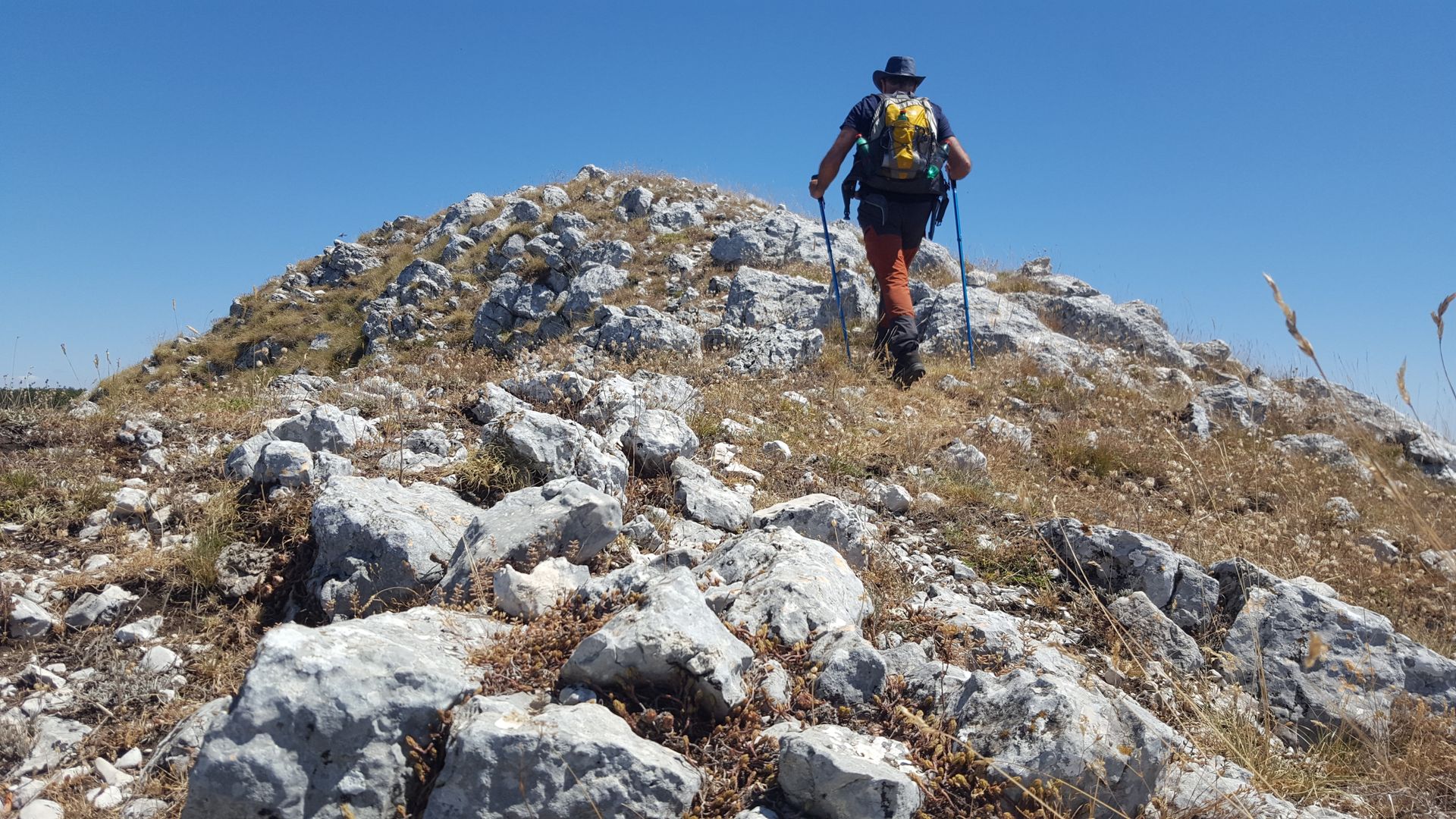 Man hiking outdoors on a rocky hill