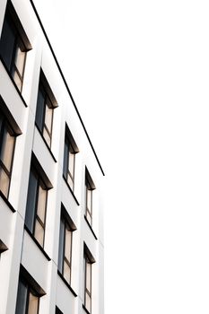 Minimalist building facade in Nitra, Slovakia. Bright exterior with white sky and windows.