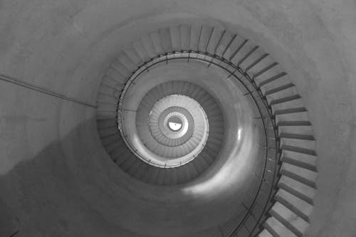 Grayscale Photo of Spiral Staircase