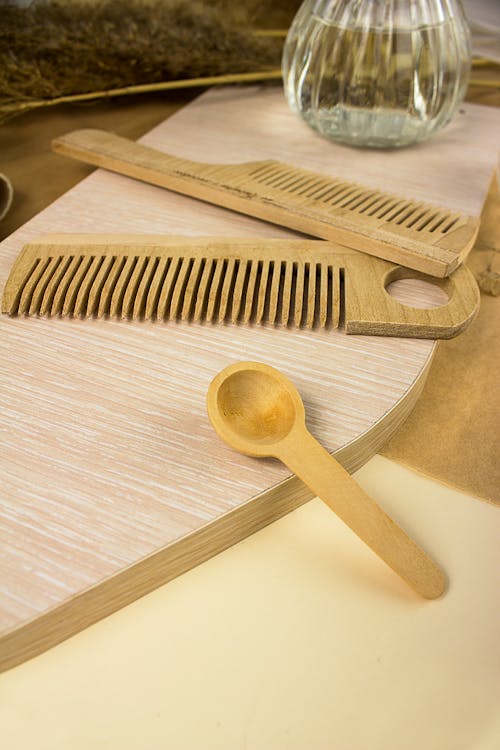 Close-up Photo of Brown Wooden Comb and Spoon