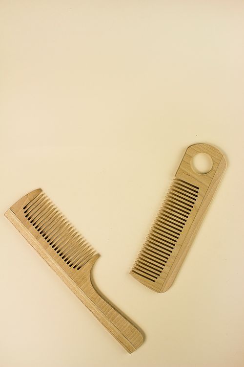 Free Two wooden combs arranged on a neutral background, ideal for natural hair care themes. Stock Photo