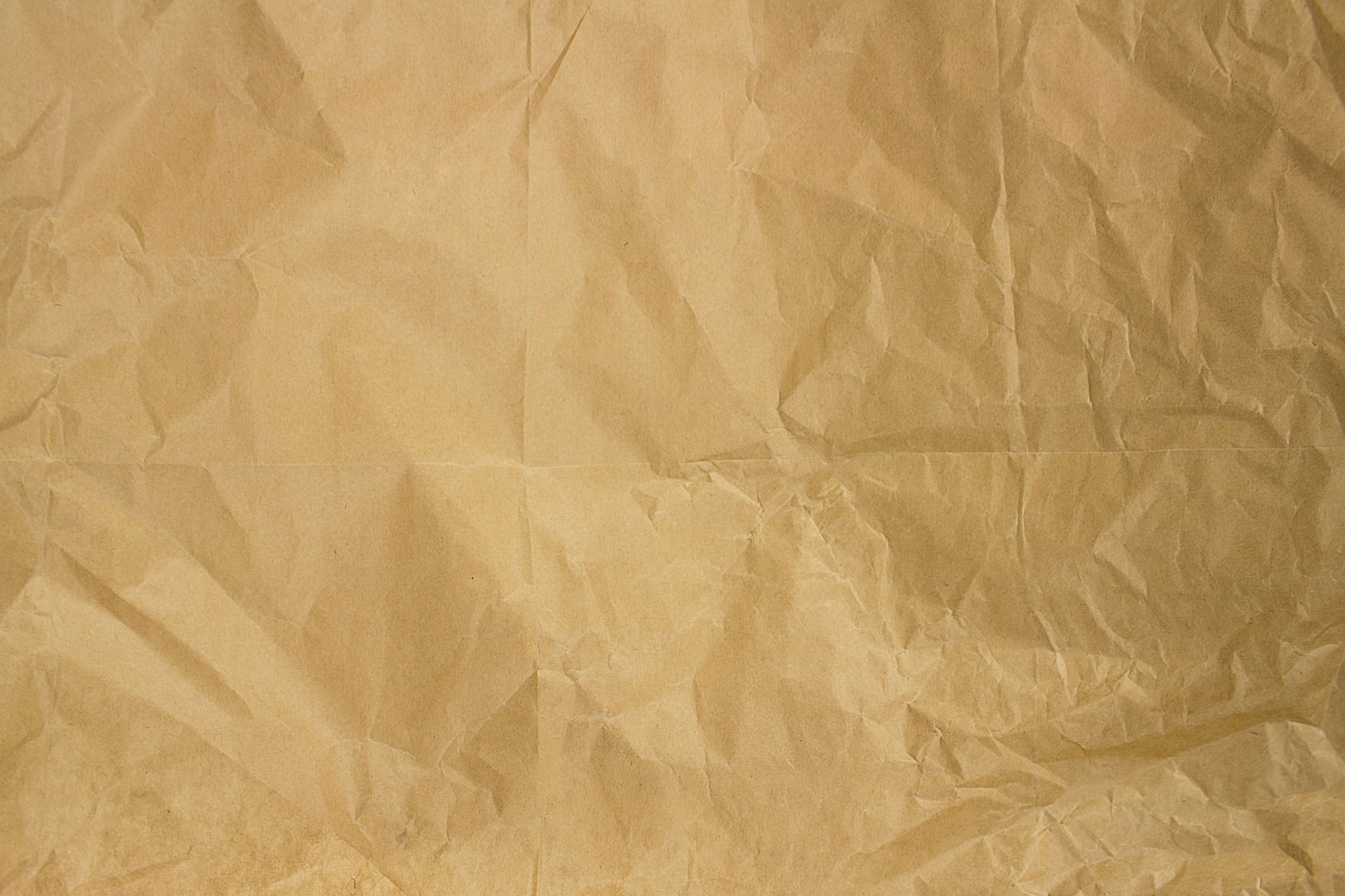 High-resolution image of crinkled buff paper providing a textured background.. high, resolution, image