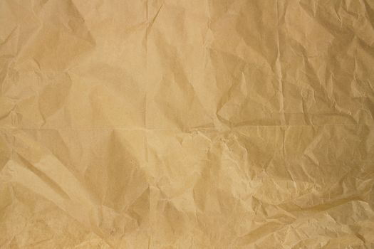 High-resolution image of crinkled buff paper providing a textured background.
