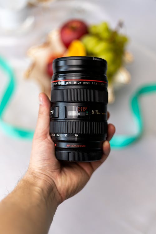 Free A Person Holding a Camera Lens Stock Photo