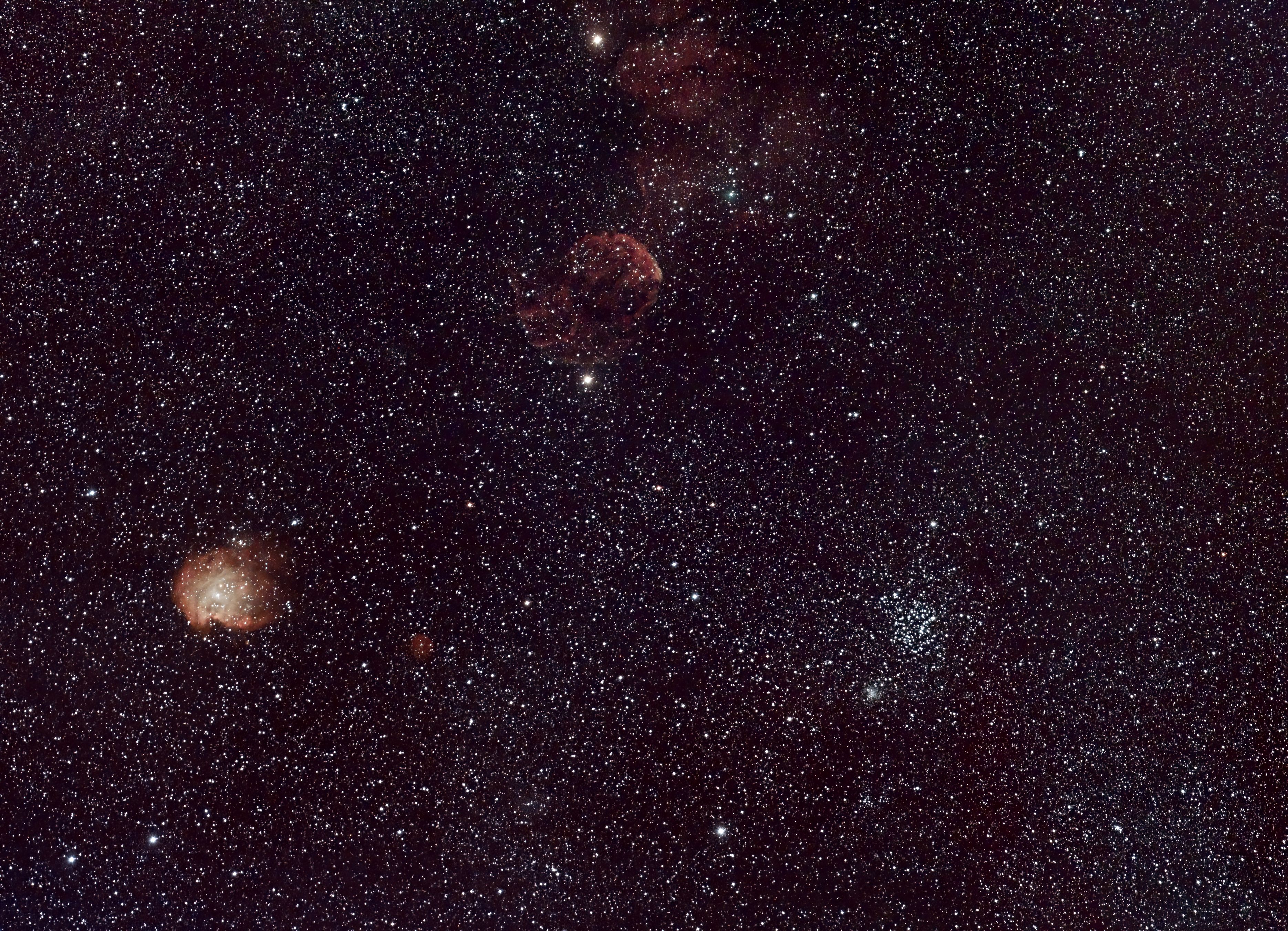 Captivating wide-angle view of a starry night sky featuring nebulae and celestial bodies.