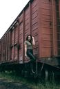 Dangerous girl hold colt near train