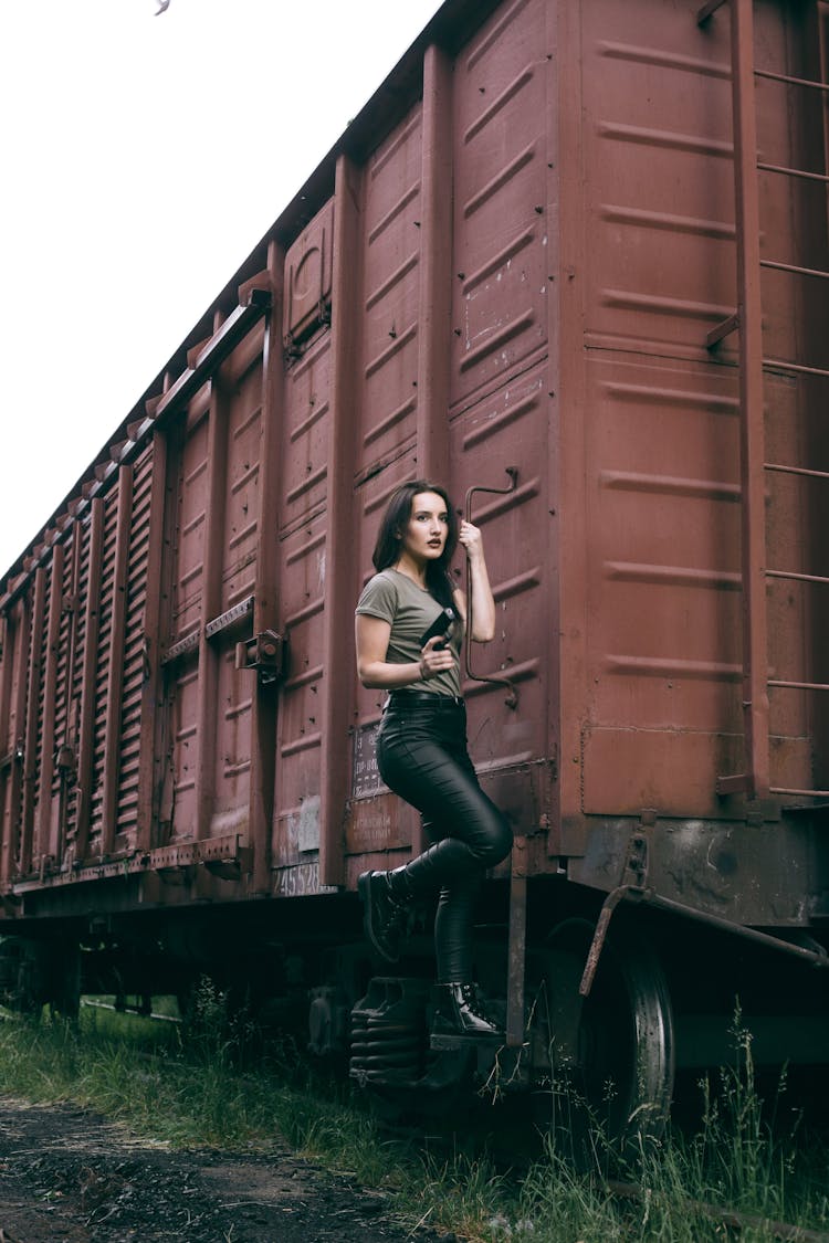 A Woman Hanging From A Cargo Train