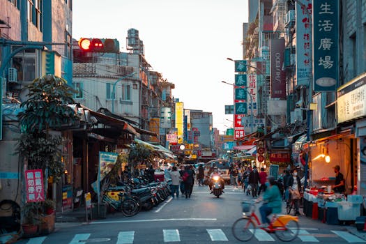 Street scene capturing the lively atmosphere of Taipei with people, shops, and vibrant signages.