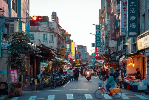 Free Street scene capturing the lively atmosphere of Taipei with people, shops, and vibrant signages. Stock Photo