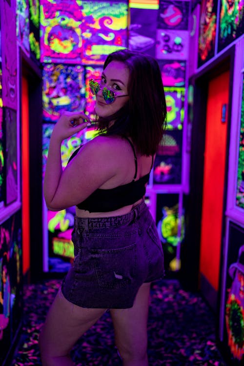 Stylish Woman in a Room filled with Neon Lights 