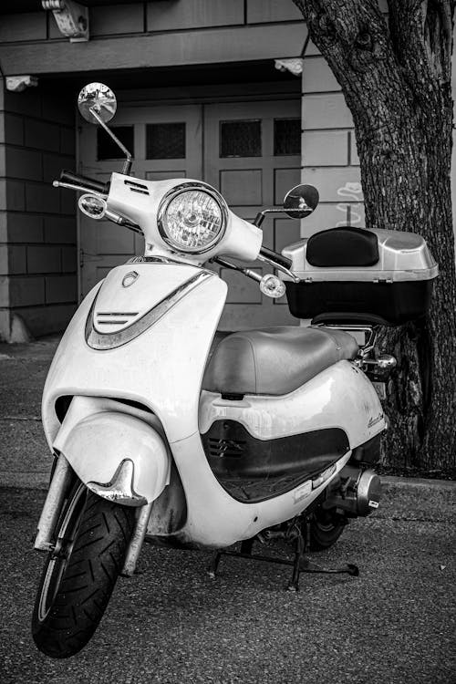 Grayscale Photo of a Parked Scooter