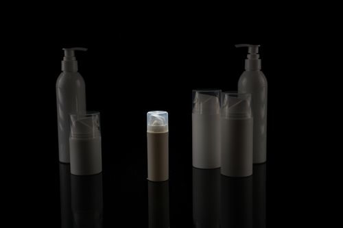 Free A collection of empty cosmetic bottles on a black background, captured in a minimalist style. Stock Photo