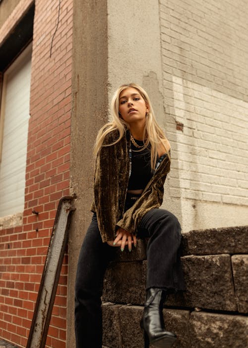 Woman Sitting Concrete Fence