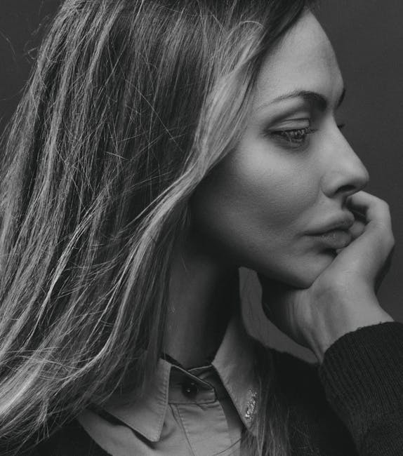 Elegant black and white side profile portrait of a woman in deep thought.