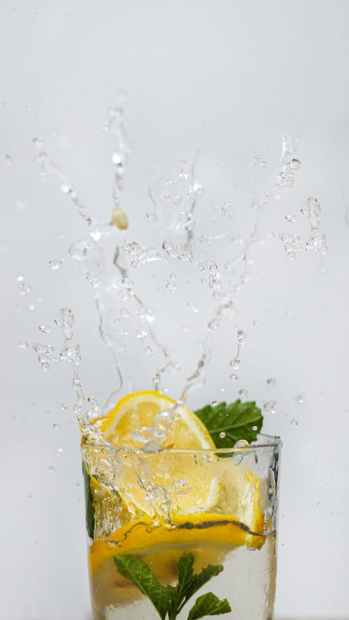 Free Lemon Slice Drop on Glass of Drink Stock Photo