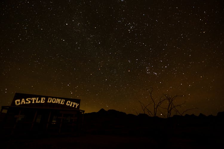 Illuminated Signage On An Establishment Under Starry Sky