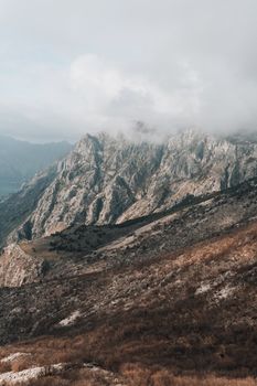 Capture of Montenegro's rugged mountains shrouded in mist, showcasing natural beauty and dramatic landscapes.