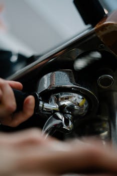 Close-up of barista pulling espresso shot using a professional coffee machine.
