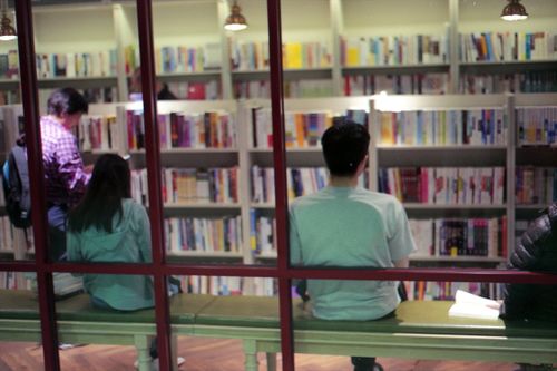 Free Capture of a vibrant bookstore interior with customers exploring aisles of books. Stock Photo