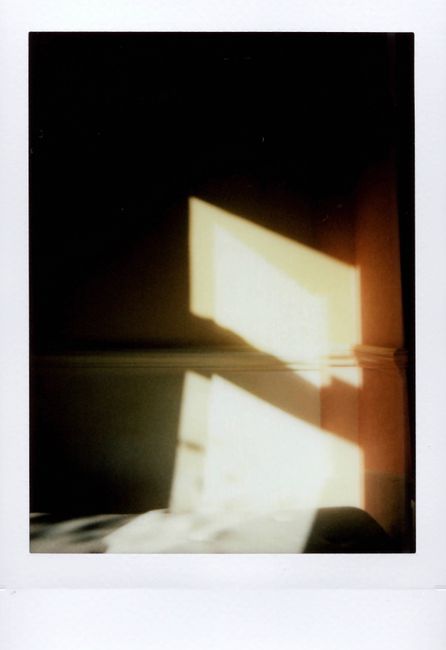 Defocused sunlight creates a serene pattern on an interior wall.
