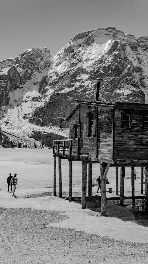 House on Stilts on a Frozen Lake in Mountains 