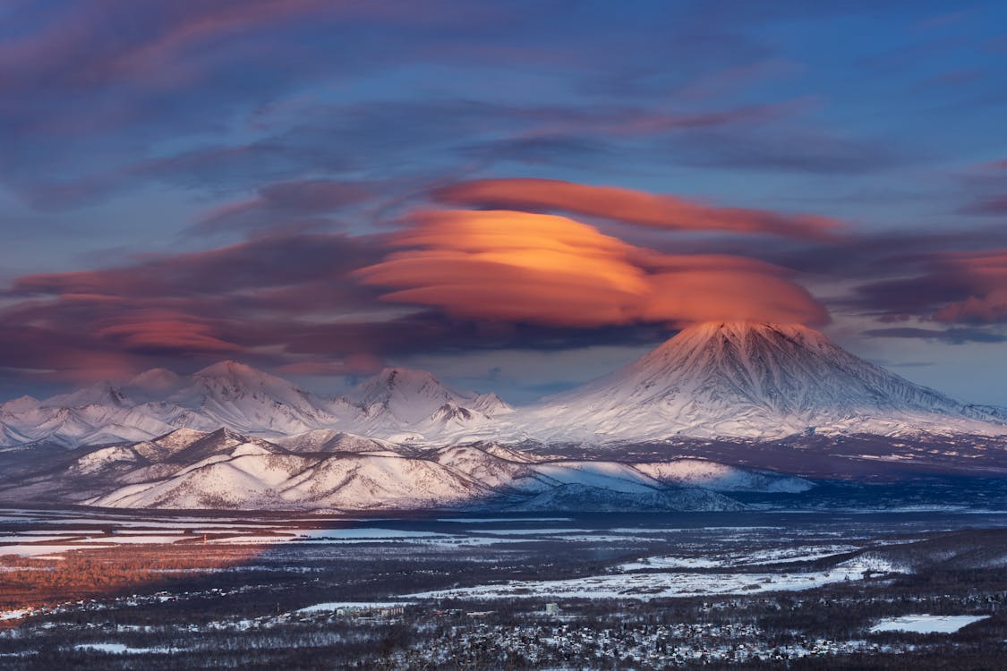 Free Sunset Over Snowcapped Mountains and Volcanoes Stock Photo