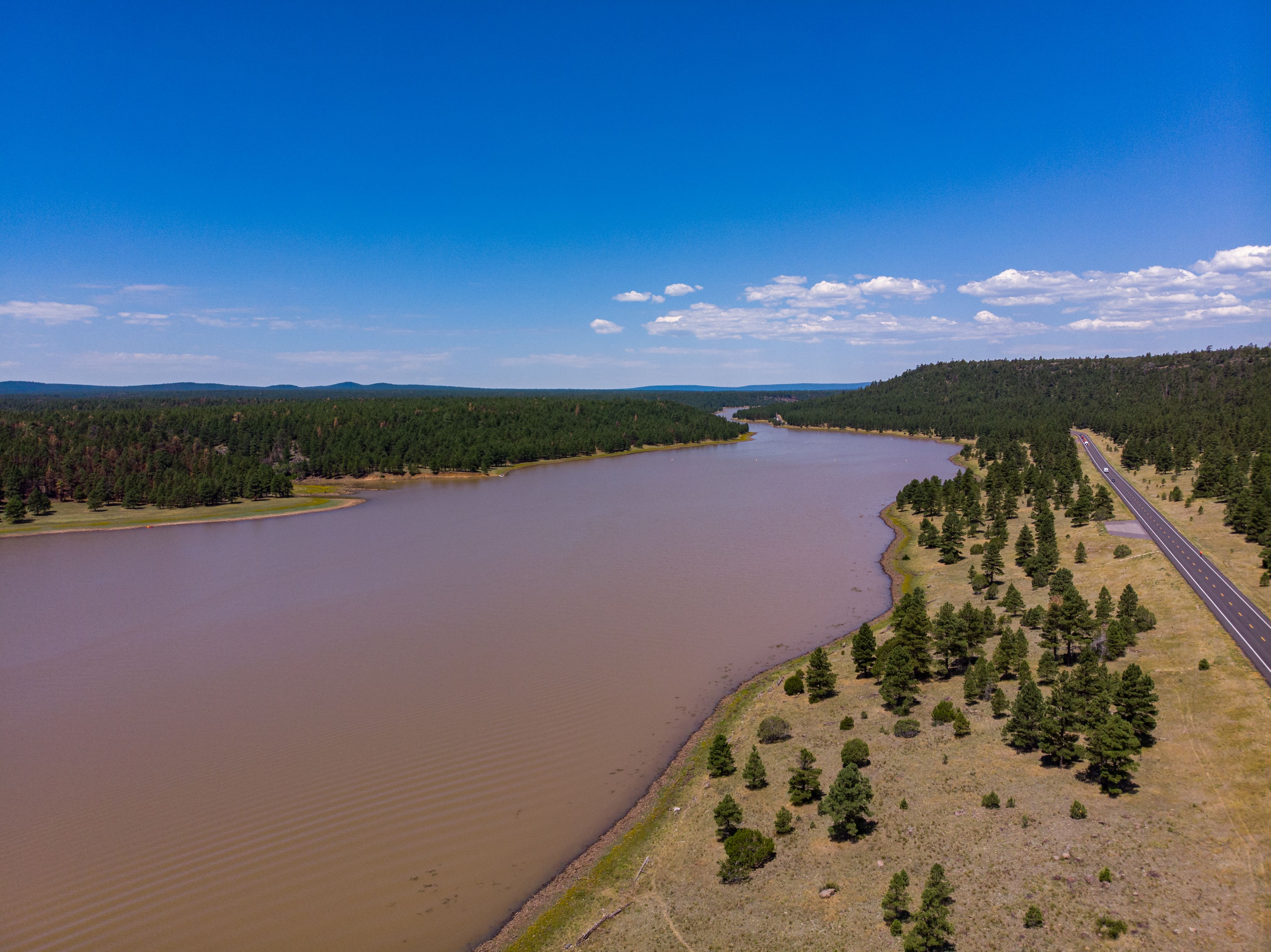 Aerial view of a lake near Flagstaff, Arizona, showcasing serene water and lush greenery.