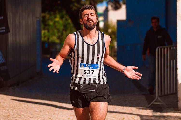 A Runner Running While Wearing Earphones