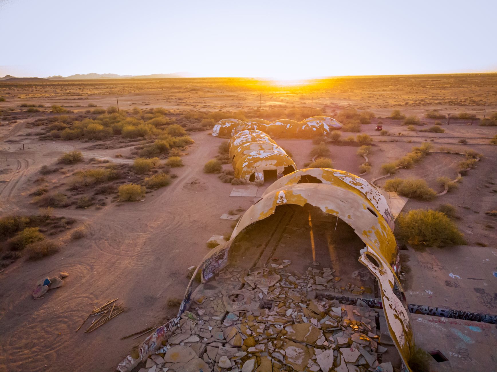 Captivating aerial shot of the Domes of Casa Grande in Arizona at sunset, showcasing desert ruins.