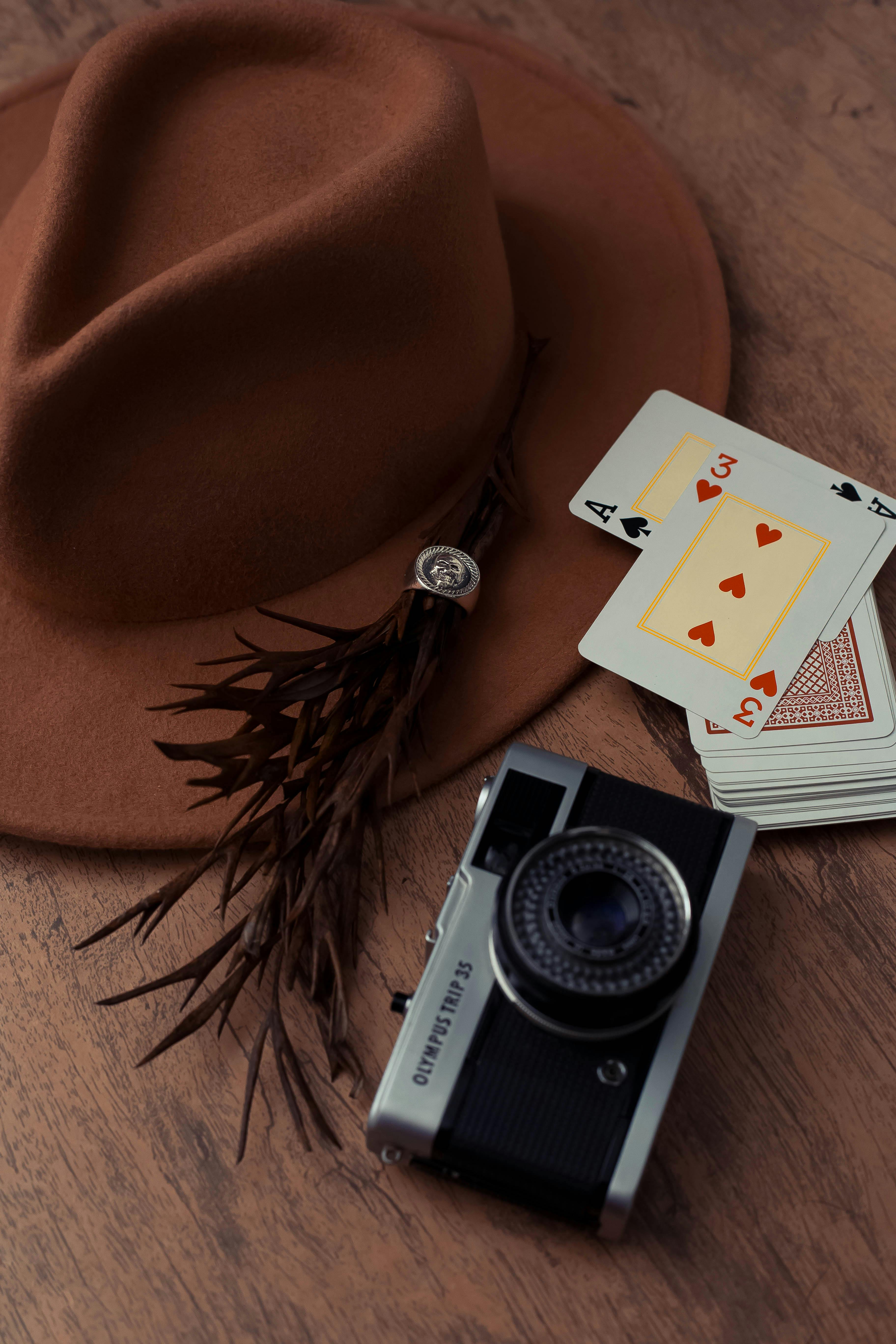 camera beside a hat