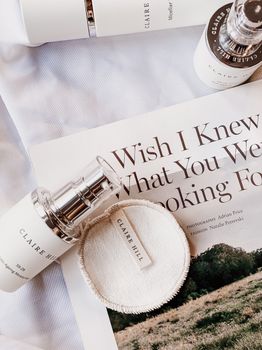 Minimalist skincare display featuring Claire Hill products on a stylish magazine background.