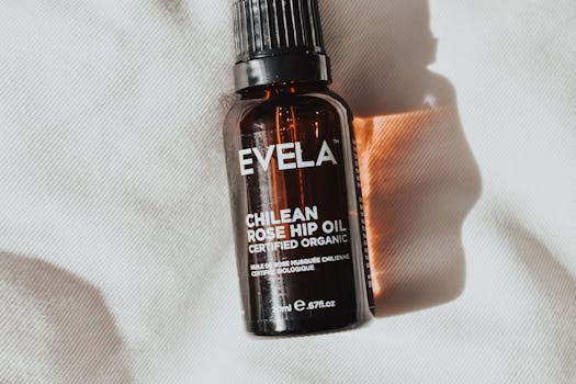 Close-up of amber bottle containing certified organic Chilean rose hip oil, with soft lighting and shadows.