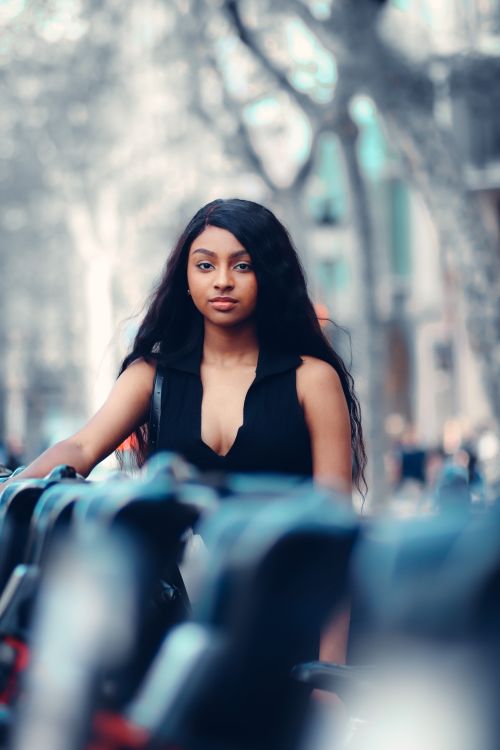 Free A fashionable young woman confidently poses outdoors, embracing urban style. Stock Photo