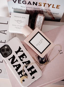 Stylish flat lay of cosmetic products, mobile accessories, and reading materials in Melbourne.