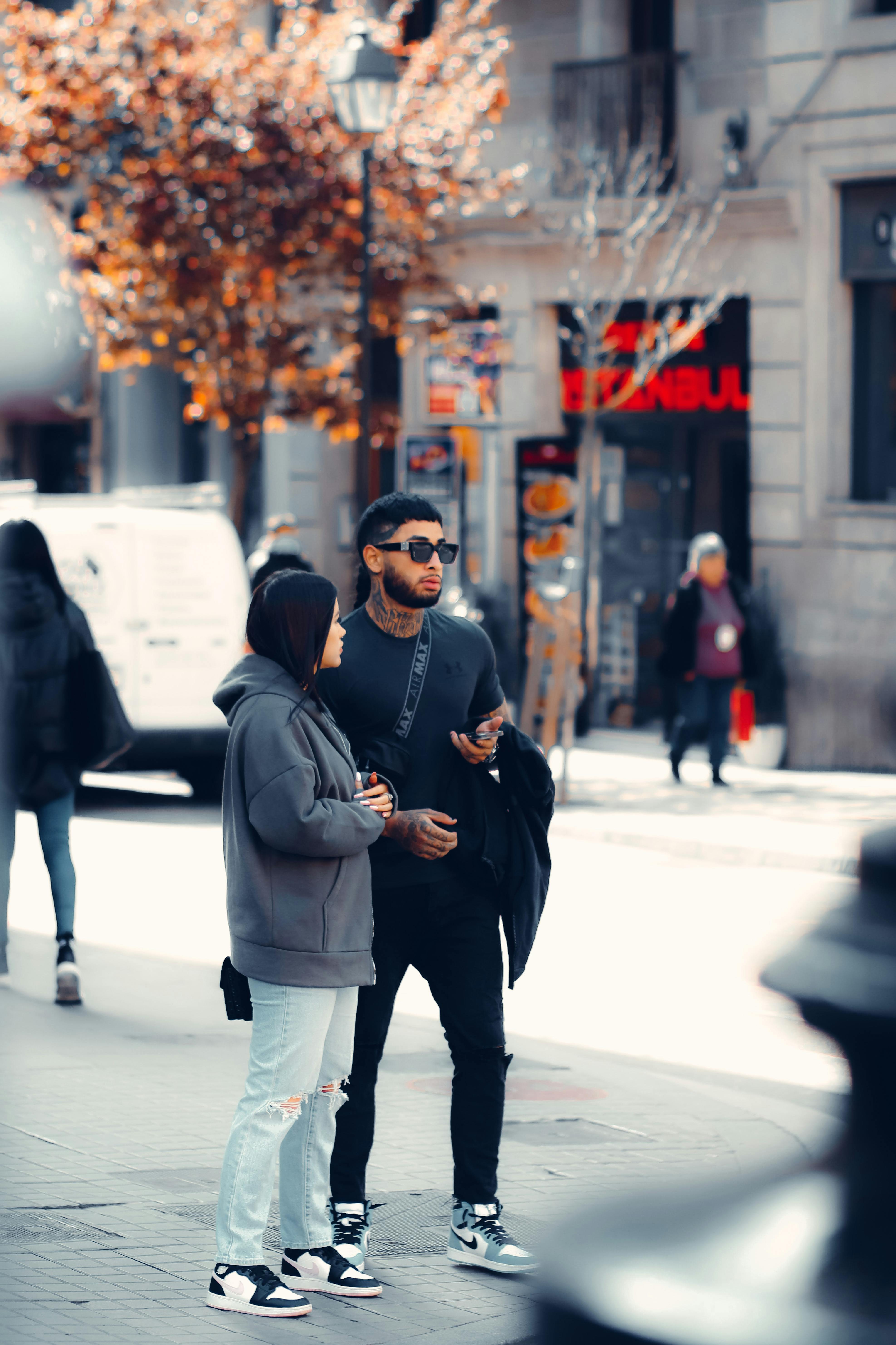 a couple standing on the sidewalk