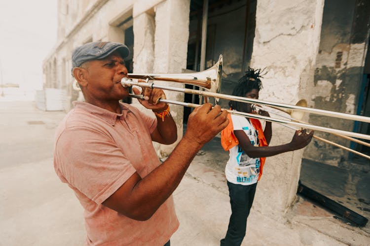 Man And Woman Playing Trumpets On Empty Street