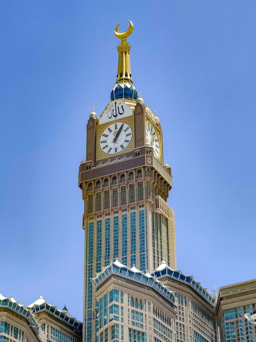 Brown and Blue Clock Tower under Blue Sky